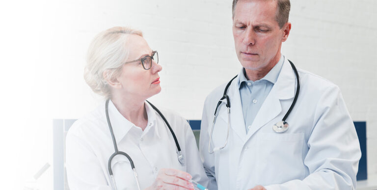 Two senior doctors in discussion.